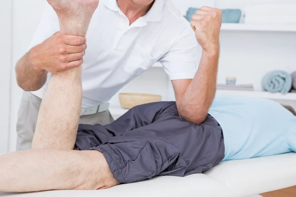 Physiotherapist doing leg massage to his patient — Stock Photo, Image