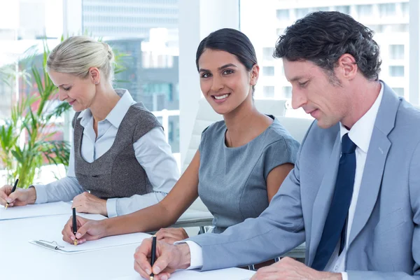 Group of business people taking notes — Stock Photo, Image