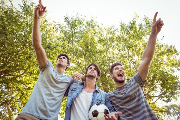 Happy friends in the park with football — Stock Photo, Image