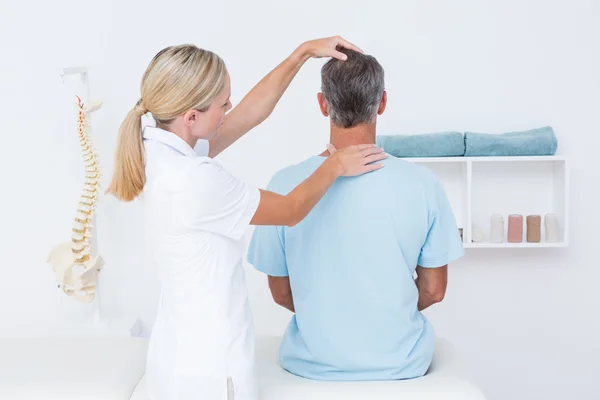 Doctor doing neck adjustment — Stock Photo, Image