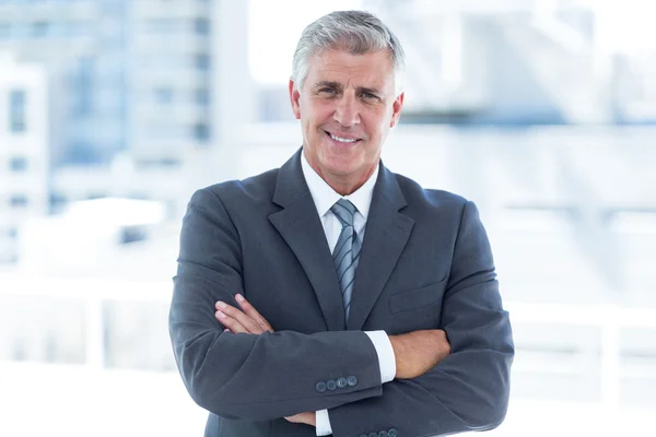 Smiling businessman with arms crossed — Stock Photo, Image