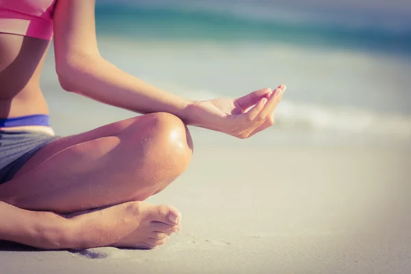 Close up view of fit woman doing yoga beside the sea — Stok fotoğraf