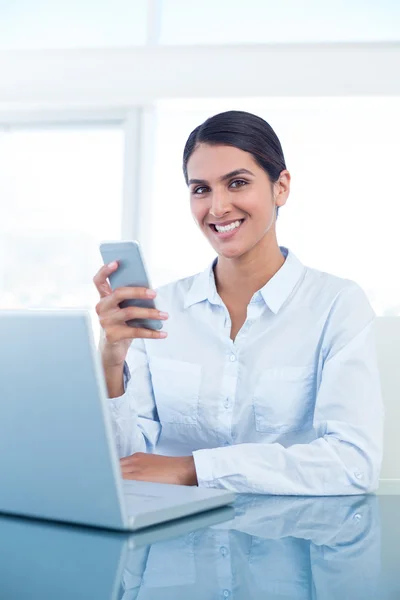 Mulher de negócios sorrindo usando seu smartphone — Fotografia de Stock