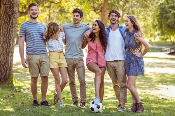 Happy friends in the park with football — Stock Photo, Image