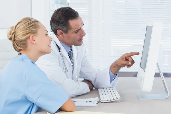 Médico y enfermera trabajando con computadora — Foto de Stock