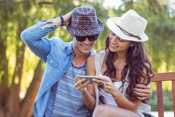 Cute couple looking at their selfies — Stock Photo, Image