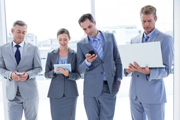 Colleghi di lavoro che utilizzano dispositivi multimediali — Foto Stock