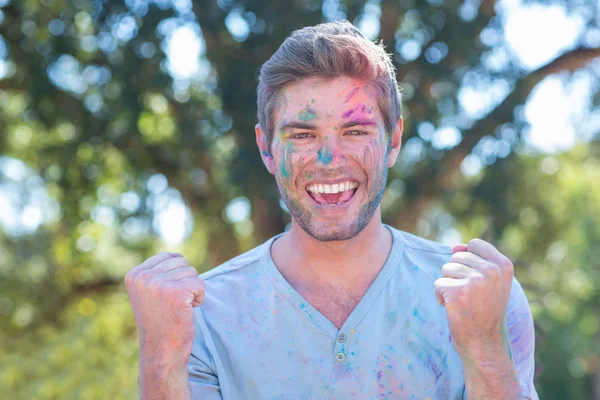 Happy man covered in powder paint — Stock Photo, Image