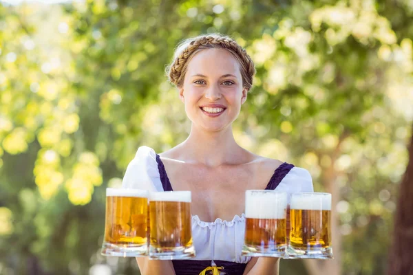 Pretty oktoberfest blonde holding beers — Stock Photo, Image