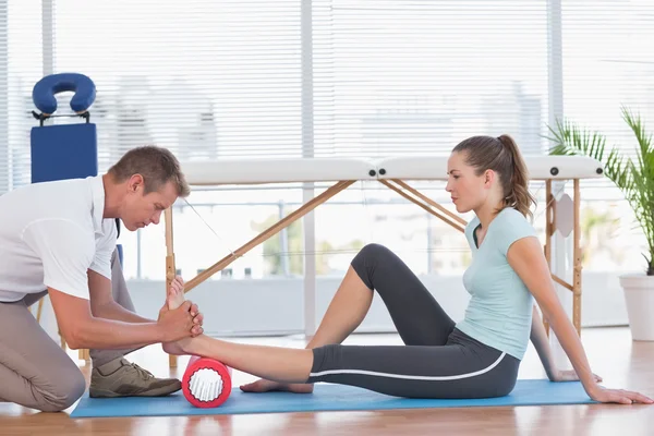 Formateur travaillant avec une femme sur un tapis d'exercice — Photo