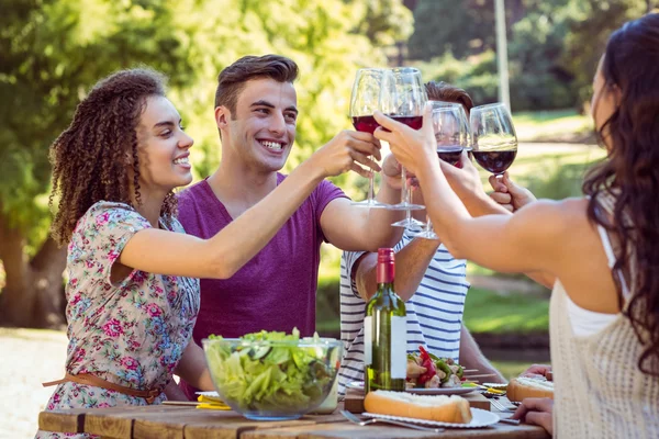 Happy vrienden in het park na de lunch — Stockfoto