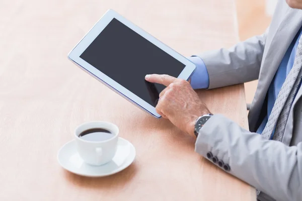 Concentrating businessman using a tablet — Stok fotoğraf