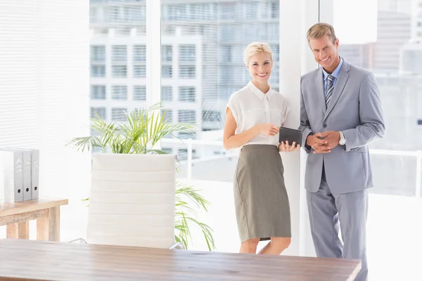Smiling business partners looking at camera — Stock Photo, Image