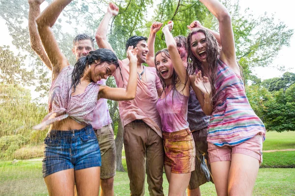 Happy friends covered in powder paint — Stock Photo, Image