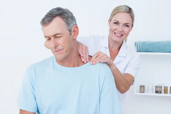 Doctor doing neck adjustment — Stock Photo, Image