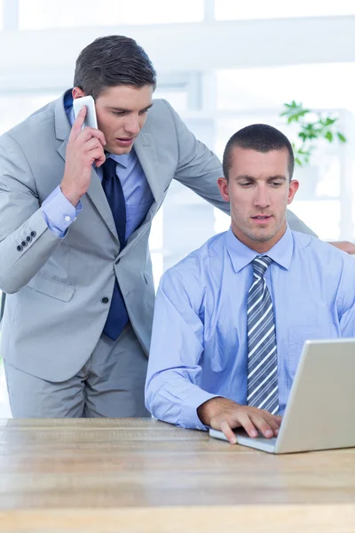 Businessmen using laptop — Stock Photo, Image