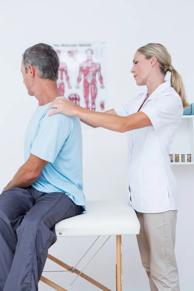 Doctor examining her patient neck — Stock Photo, Image