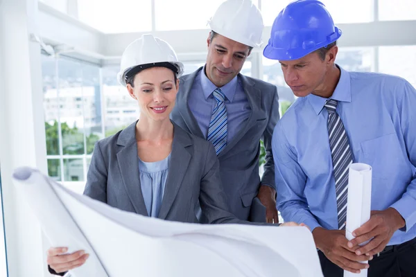 Businessmen and woman with hard hats — Stock Photo, Image