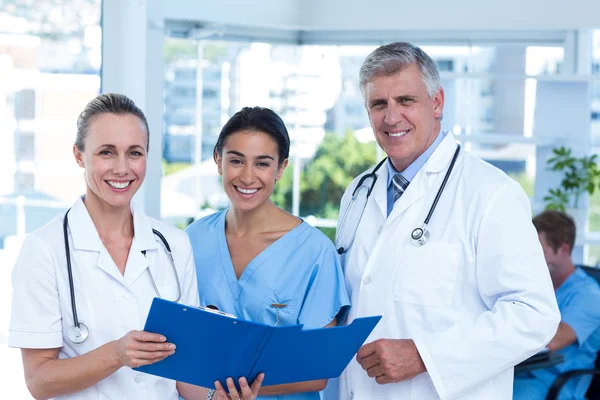 Team of doctors working on their files — Stock Photo, Image