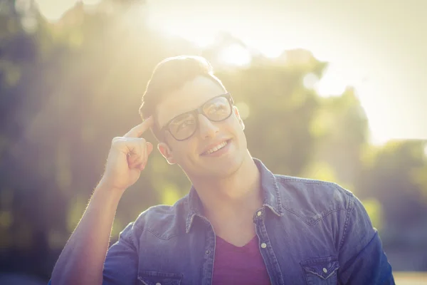 Handsome thinking hipster in the park — Stock Photo, Image