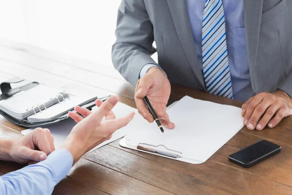 Businessman explaining contract to co worker — Stock Photo, Image