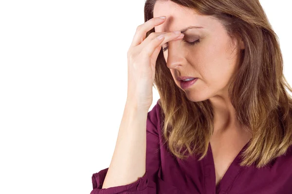 Pretty brunette with headache touching her forehead — Stock fotografie