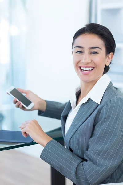 Businesswoman using smartphone and tablet — Stock Photo, Image