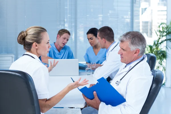 Team of doctors working on their files — Stock Photo, Image