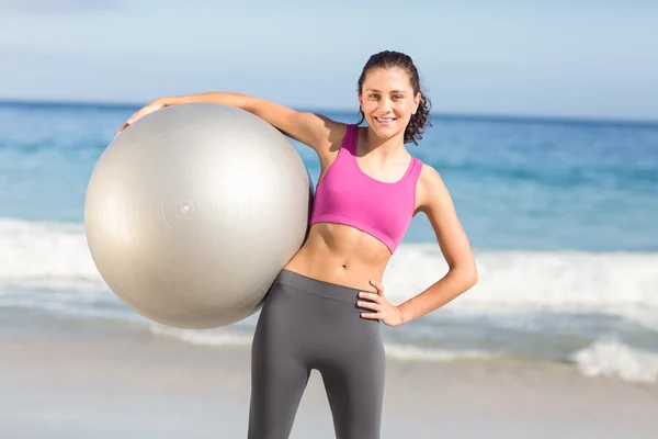 Happy fit woman holding exercise ball — Stok fotoğraf
