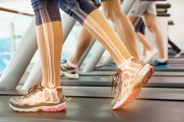 Highlighted ankle of woman on treadmill — Stock Photo, Image