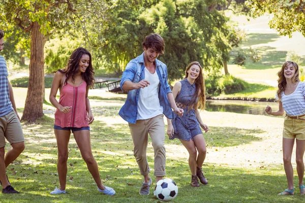 Happy friends in the park with football — Stock Photo, Image