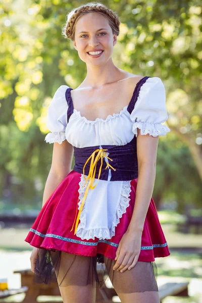 Pretty oktoberfest blonde smiling in the park — Stock Photo, Image