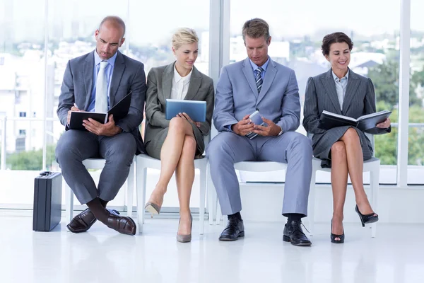 Mensen uit het bedrijfsleven te wachten om te worden aangeroepen in interview — Stockfoto