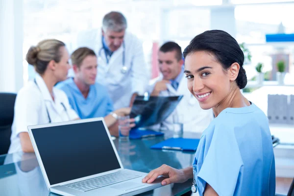 Smiling doctor typing on keyboard — Stock Photo, Image