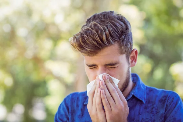 Handsome hipster blowing his nose — Stock Photo, Image