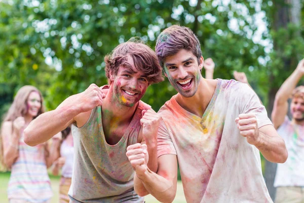 Happy friends covered in powder paint — Stock Photo, Image