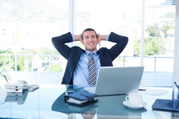 Businessman relaxing in swivel chair — Stock Photo, Image