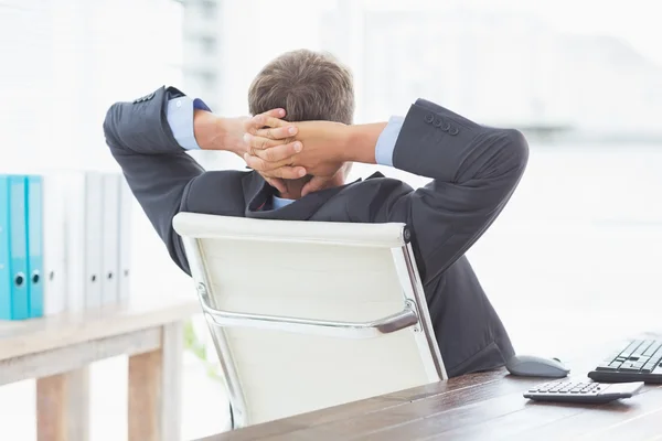 Businessman relaxing in a swivel chair leaning back — Stock Photo, Image