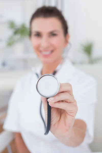 Médico mostrando estetoscópio para câmera — Fotografia de Stock