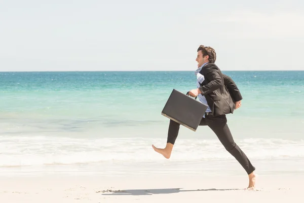 Businessman jumping in front of the sea — 스톡 사진