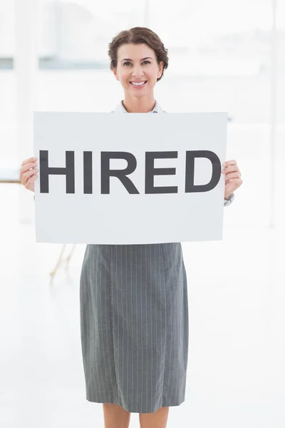 Businesswoman holding sign in front of her — Stock Photo, Image