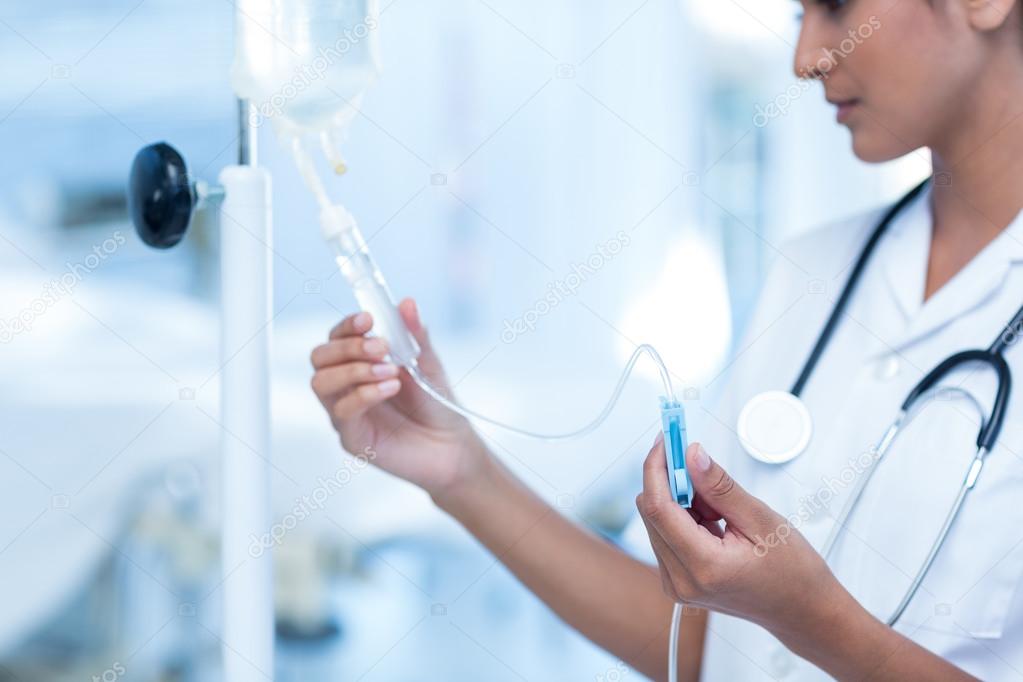 Nurse connecting an intravenous drip — Stock Photo © Wavebreakmedia 76431043
