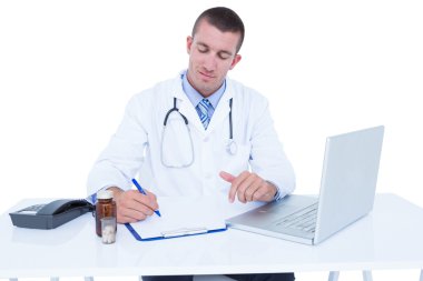 Doctor writing on a notebook clipart