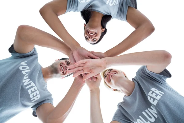 Happy volunteers putting their hands together — Stock Photo, Image