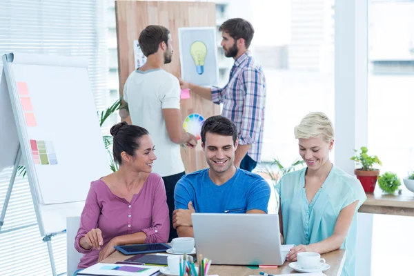 Creative colleagues using laptop in meeting — Stock Photo, Image