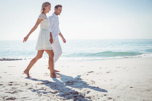 Пара тримається за руки і стоїть на пляжі — стокове фото