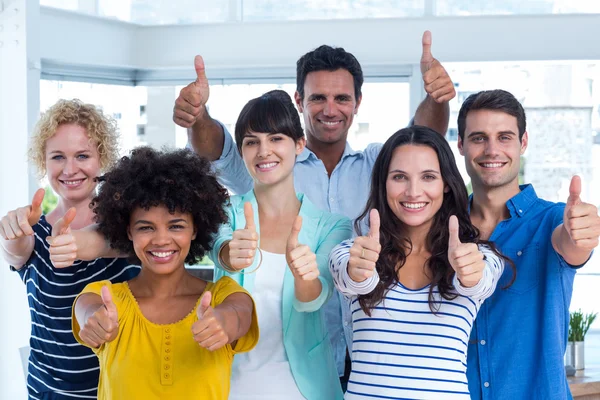 Portrait of creative team gesturing thumbs up — Stock Photo, Image