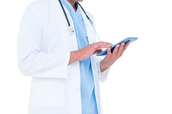 Standing doctor using his tablet — Stock Photo, Image