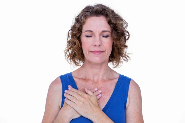 Brunette with her hands on heart — Stock Photo, Image