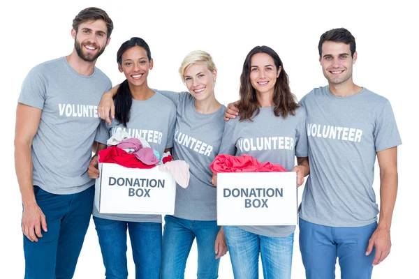 Happy volunteers friends holding donation boxes — Stock Photo, Image